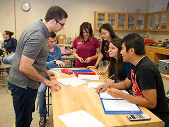 Five students and a professor doing a lab experiment